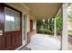 Charming covered front porch features a decorative door with glass and brick accents for curb appeal at 1336 Nathan Mauldin Dr, Lawrenceville, GA 30043