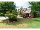Landscaped front yard featuring mature trees, green grass, and a charming two-story home at 1336 Nathan Mauldin Dr, Lawrenceville, GA 30043