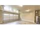 A clean, spacious garage with an insulated door, overhead lighting and water heater at 1336 Nathan Mauldin Dr, Lawrenceville, GA 30043