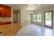 Eat-in kitchen featuring granite countertops and neutral tile flooring next to a door leading to the backyard at 1336 Nathan Mauldin Dr, Lawrenceville, GA 30043
