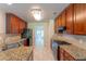 Modern kitchen with granite countertops, stainless steel appliances, and tile flooring at 1336 Nathan Mauldin Dr, Lawrenceville, GA 30043