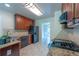 Galley kitchen with granite countertops, dark cabinets, and stainless steel appliances at 1336 Nathan Mauldin Dr, Lawrenceville, GA 30043