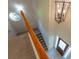 Open staircase with wood railing, chandelier, octagonal window, and views of the front door at 1336 Nathan Mauldin Dr, Lawrenceville, GA 30043