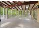 Open-air outdoor back porch with vaulted ceilings, ceiling fans, skylights, and great views of the outdoor foliage at 2697 N Thompson Ne Rd, Atlanta, GA 30319