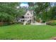 Expansive backyard view featuring lush green lawn and multi-tiered deck on this tan two-story home at 2697 N Thompson Ne Rd, Atlanta, GA 30319