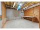 Unfinished basement area with exposed insulation, concrete flooring, and a small window providing natural light at 2697 N Thompson Ne Rd, Atlanta, GA 30319