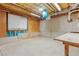 Unfinished basement area featuring exposed insulation, concrete flooring, and a small window for natural light at 2697 N Thompson Ne Rd, Atlanta, GA 30319