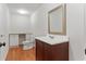 Neat bathroom with wood-look flooring, granite countertop, a toilet, and a framed mirror at 2697 N Thompson Ne Rd, Atlanta, GA 30319