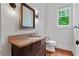 Half bathroom featuring hardwood floors, granite counters and updated vanity at 2697 N Thompson Ne Rd, Atlanta, GA 30319