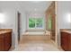 Bright primary bathroom featuring large tub, glass shower, and double sink vanity at 2697 N Thompson Ne Rd, Atlanta, GA 30319