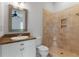 Bathroom featuring a neutral-tiled walk-in shower, vanity with granite counter, and modern fixtures at 2697 N Thompson Ne Rd, Atlanta, GA 30319