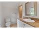 Bright bathroom featuring tiled floors, granite countertop, and a large mirror with a decorative silver frame at 2697 N Thompson Ne Rd, Atlanta, GA 30319