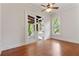 Bedroom with hardwood floors, doors leading to porch and large window with wooded backyard view at 2697 N Thompson Ne Rd, Atlanta, GA 30319