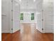 Spacious closet area with hardwood floors, lighting fixtures, shelving, and large open doorway at 2697 N Thompson Ne Rd, Atlanta, GA 30319