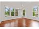Dining room featuring hardwood floors, recessed lighting, a chandelier, and large windows offering serene views at 2697 N Thompson Ne Rd, Atlanta, GA 30319
