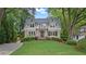 Charming two-story home featuring a manicured lawn, mature trees, and inviting curb appeal with a second story balcony at 2697 N Thompson Ne Rd, Atlanta, GA 30319
