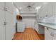 Spacious laundry room with ample cabinetry, countertop space, utility sink, and wood-look flooring at 2697 N Thompson Ne Rd, Atlanta, GA 30319