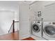 Convenient laundry area with washer, dryer, and overhead storage shelving, located near the staircase landing at 2697 N Thompson Ne Rd, Atlanta, GA 30319