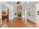 Open living room featuring stone fireplace, hardwood floors, and plenty of natural light at 2697 N Thompson Ne Rd, Atlanta, GA 30319