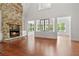Inviting living room with a stone fireplace, hardwood floors, and an abundance of natural light at 2697 N Thompson Ne Rd, Atlanta, GA 30319