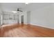 Open-concept living room with hardwood floors, built-in shelving, a ceiling fan, and neutral wall colors at 2697 N Thompson Ne Rd, Atlanta, GA 30319