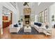 Bright and airy living room featuring a stone fireplace, high ceilings, built-in shelving, and an open concept design at 2697 N Thompson Ne Rd, Atlanta, GA 30319