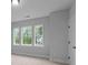 Bedroom with three windows and a partial view of neighborhood homes at 4830 Briscoe Dr, Cumming, GA 30028