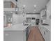 Kitchen with an island, modern appliances, pendant lighting and white subway tile backsplash at 4830 Briscoe Dr, Cumming, GA 30028