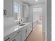 Kitchen features white cabinets, sleek countertops, stainless steel sink, and a window view of the outdoors at 4830 Briscoe Dr, Cumming, GA 30028