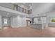 Open-concept living space with high ceilings, hardwood floors, and seamless transition to the modern kitchen at 4830 Briscoe Dr, Cumming, GA 30028