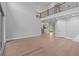 Expansive living room with light-colored walls, hardwood floors, with a view of the staircase and kitchen at 4830 Briscoe Dr, Cumming, GA 30028
