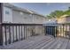 View of the wooden deck with a stainless steel grill and townhouse view at 5381 Briar Creek Ln, Norcross, GA 30071