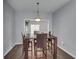 Dining room with modern furnishings and lighting, leading to a bright living space at 5381 Briar Creek Ln, Norcross, GA 30071