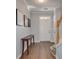 Welcoming foyer with wood floors, console table, white door, and staircase at 5381 Briar Creek Ln, Norcross, GA 30071