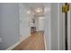 Hallway with luxury vinyl plank flooring, white doors, and a view of the foyer at 5381 Briar Creek Ln, Norcross, GA 30071