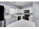 Well-lit kitchen featuring white cabinetry, black appliances, and a functional island at 5381 Briar Creek Ln, Norcross, GA 30071