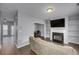 Open living room with fireplace, built in shelves, and view into the dining area at 5381 Briar Creek Ln, Norcross, GA 30071