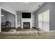 Inviting living room features a fireplace, built-in shelves, and abundant natural light from the window at 5381 Briar Creek Ln, Norcross, GA 30071
