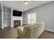 Comfortable living room featuring a fireplace with custom shelving, and bright window lighting at 5381 Briar Creek Ln, Norcross, GA 30071