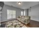 Bright living room featuring a fireplace, hardwood floors, and a comfortable sofa at 5381 Briar Creek Ln, Norcross, GA 30071