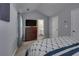 Bright main bedroom includes a closet and a wooden dresser for storage at 5381 Briar Creek Ln, Norcross, GA 30071