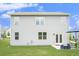 Rear exterior view of the house shows the siding, windows, and patio access to the lawn at 7814 Messina Ct, Lithia Springs, GA 30122