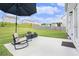 Lush backyard featuring a concrete patio with a comfortable lounge area and manicured green grass at 7814 Messina Ct, Lithia Springs, GA 30122
