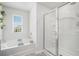 Bright bathroom with soaking tub and glass enclosed shower with window for natural light at 7814 Messina Ct, Lithia Springs, GA 30122