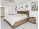 Spacious bedroom showcasing a wooden bed frame, neutral decor, and ample natural light at 7814 Messina Ct, Lithia Springs, GA 30122