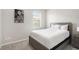 Well-lit bedroom with gray wood furnishings and a soft carpeted floor at 7814 Messina Ct, Lithia Springs, GA 30122