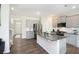 The kitchen features gray cabinets, granite countertops, stainless appliances, and an island with bar seating at 7814 Messina Ct, Lithia Springs, GA 30122