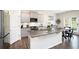 Modern kitchen with stainless steel appliances, granite countertops, a central island, and stylish gray cabinetry at 7814 Messina Ct, Lithia Springs, GA 30122