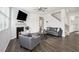 A comfortable living room with hardwood floors, a fireplace, and a view of the staircase at 7814 Messina Ct, Lithia Springs, GA 30122