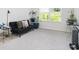 Cozy living room features a comfortable futon sofa, bright windows, and modern decor at 7814 Messina Ct, Lithia Springs, GA 30122